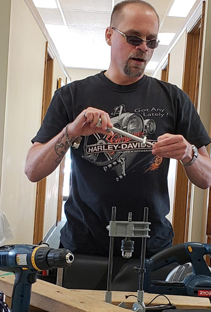 Man learning about tools in class