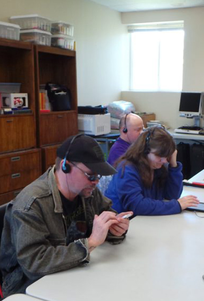 Students in a class listening with headphones
